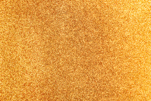 A glittering background surface area of vibrant gold.