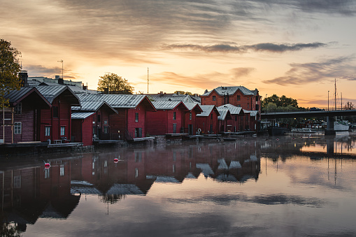 Red wooden houses on the canal at sunrise in Porvoo, Finland