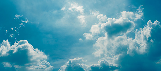 sunlight shining through clouds and blue sky background, panoramic angle view