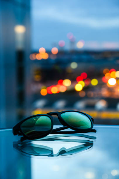 istock Cityscape Reflecting in Blue Shades on Table 1752479654