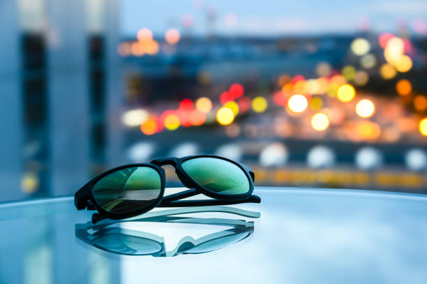 istock Blue Cityscape Reflected on Table with Sunglasses and Architecture 1752479878