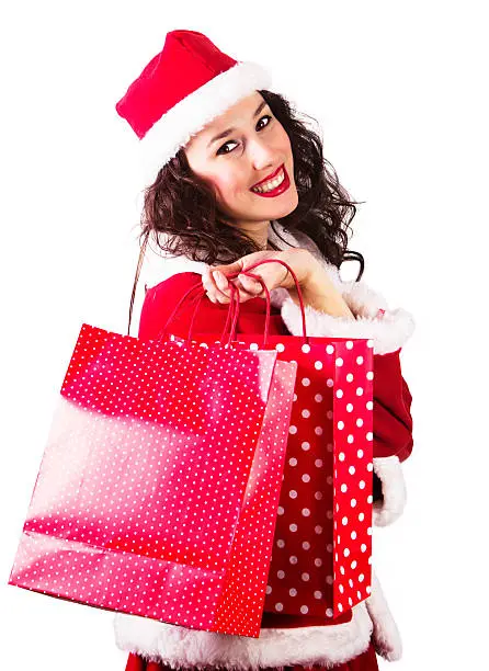 Pretty Mrs.Claus holding shopping bags on isolated white background
