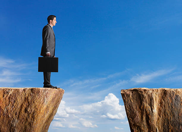 istock Business standing at edge of cliff looking towards other side 175248320