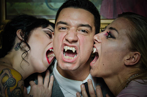 Vampires Showing of Their Fangs Group of vampires showing of their fangs vampire three people raleighlypse color image stock pictures, royalty-free photos & images