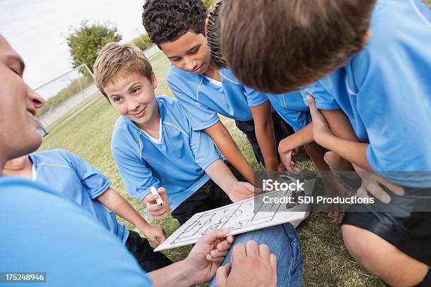 Kids Soccer Team Receiving Directions During Game From Coach Stock Photo - Download Image Now