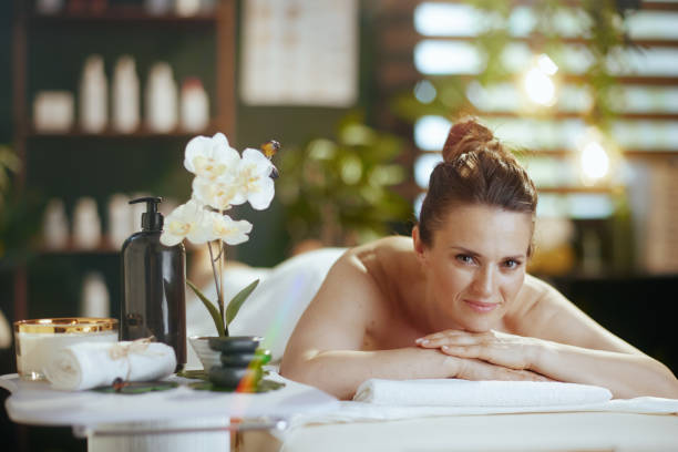 istock relaxed modern woman in massage cabinet laying on massage table 1752491059
