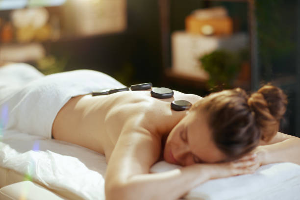 istock woman having hot stone massage and laying on massage table 1752491064