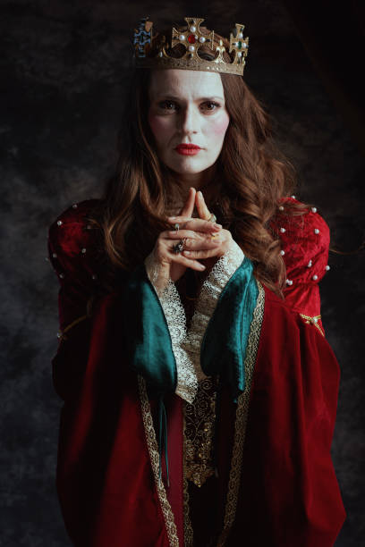 istock medieval queen in red dress with white makeup and crown 1752491068