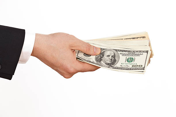 istock businessman holding dollars 175249473