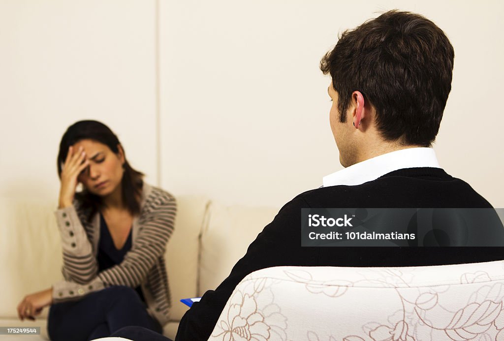 Psychiatrist and Patient Female patient on counseling session with psychiatrist.She seems so sad Interview - Event Stock Photo