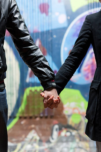 istock Young couple holding hands on the street 175249549
