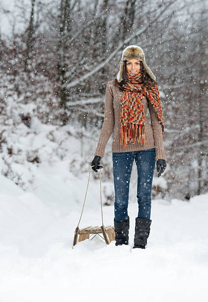 istock Winter Fun, Woman pulling a Wooden Sled, Copy Space 175250001
