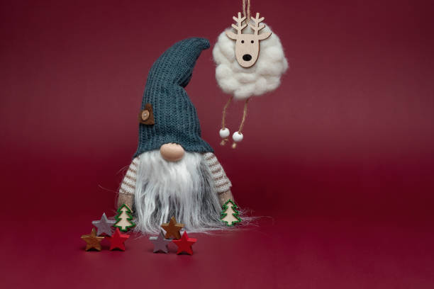 istock Elf in grey hat with reindeer and christmas stars. 1752506825