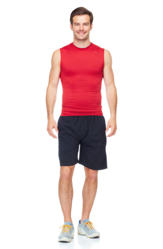 A full length studio portrait of an athletic young man isolated on white