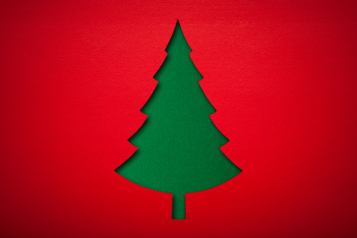 Paper Christmas tree  on red Background.