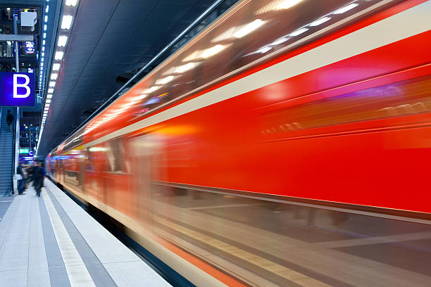 istock High speed commuter train speeding at railway station platform 175251333