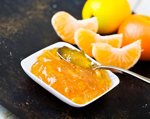 orange jam petit déjeuner - gelatin dessert orange fruit marmalade photos et images de collection