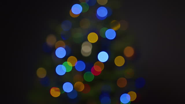 Blurred blinking Christmas lights. Flares out of focus