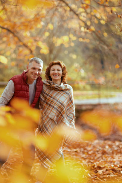 istock smiling romantic couple in park walking 1752521048