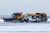 Snowblower cleans airport taxiway in a blizzard