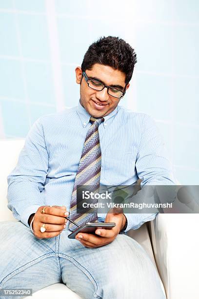 Cheerful Friendly Indian Businessman Using Smart Phone Stock Photo - Download Image Now