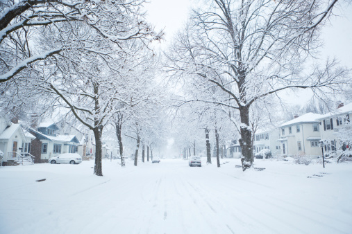 Subject: A winter snow storm in a residential area of the city.