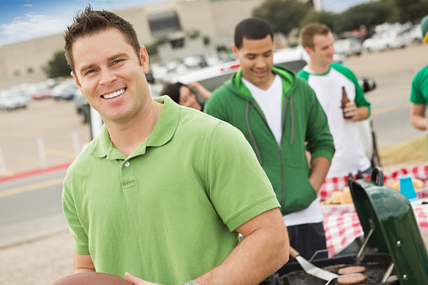 istock Man tailgating with friends, cooking out near stadium 175252877