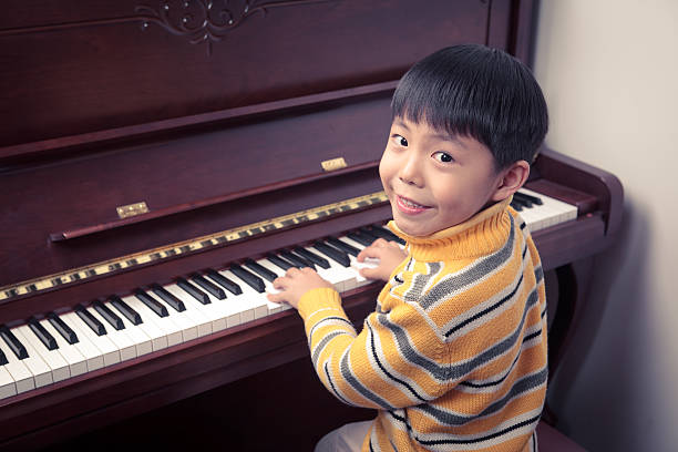 istock Little boys playing the piano 175253242