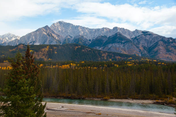 istock Autumn lanscape with mountains, yellow and green forest and a river. 1752533088