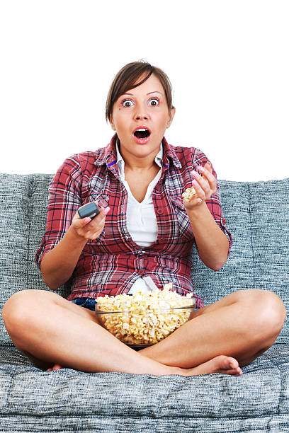 istock Young woman eating popcorn 175253597