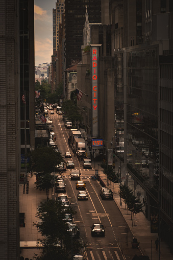 Radio City Music Hall, New York , USA - September 15, 2023.  An elevated view of West 51st Street in Midtown Manhattan at sunset with Radio City Music Hall sign and New York traffic