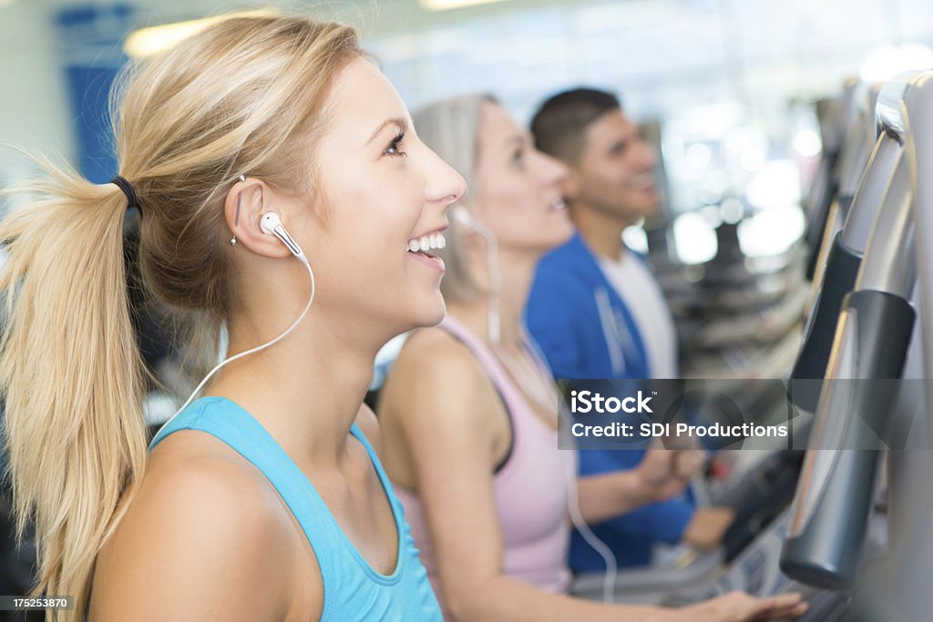 Group of people on treadmills at gym watching TV Treadmill Stock Photo