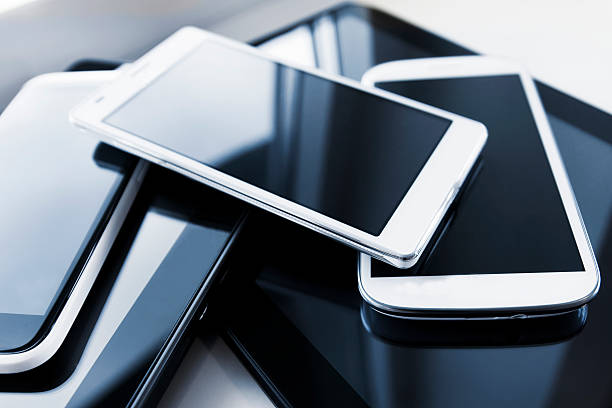 Pile of new mobile phones and digital tablets
