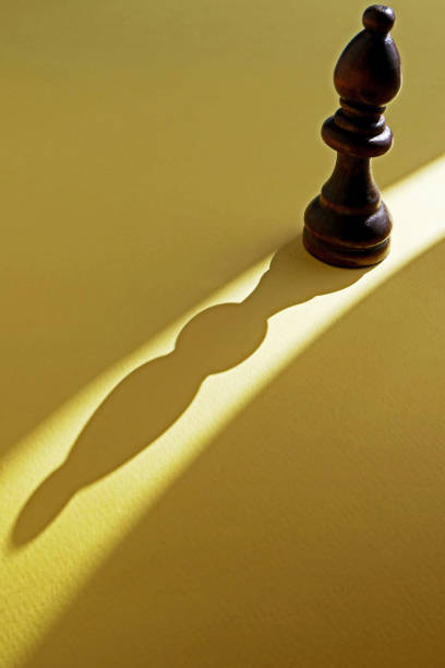 istock A chess piece and its shadow on a yellow background 1752541713