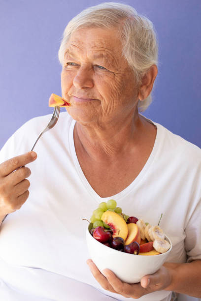 istock Old Woman Eating Fruit Salad 1752543998