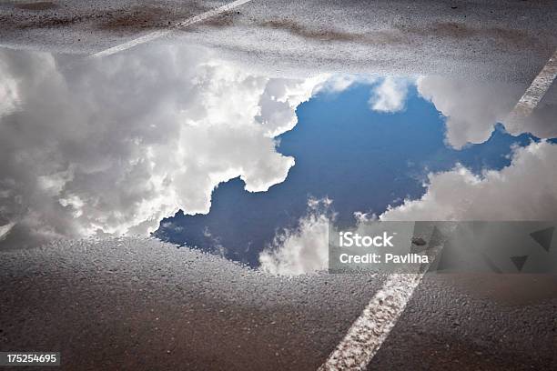 Sky With Clouds Reflected In A Puddle Stock Photo - Download Image Now - Puddle, Sky, Blue