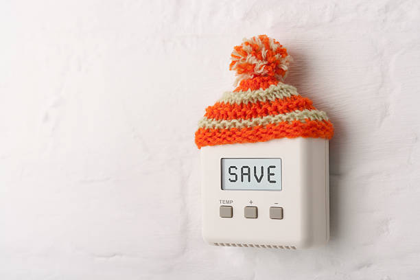 SAVE on digital room thermostat with wooly hat stock photo