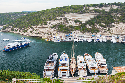 Bonifacio, France - August 22, 2018: Pleasure motorboats and sailing yachts are moored in Bonifacio harbor