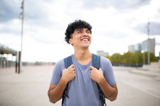 istock smiling young man with bag looking away 1752553559