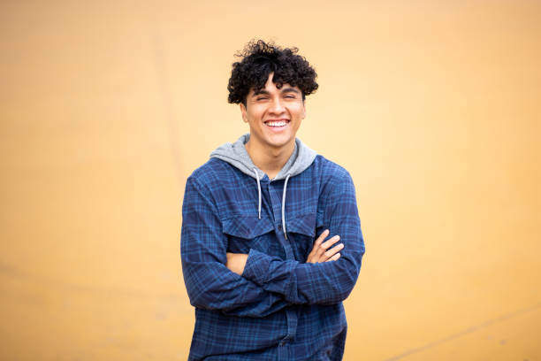 istock smiling young man with arms crossed 1752554723