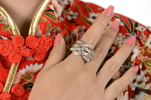Diamond ring on finger and Chinese Cheongsam dress