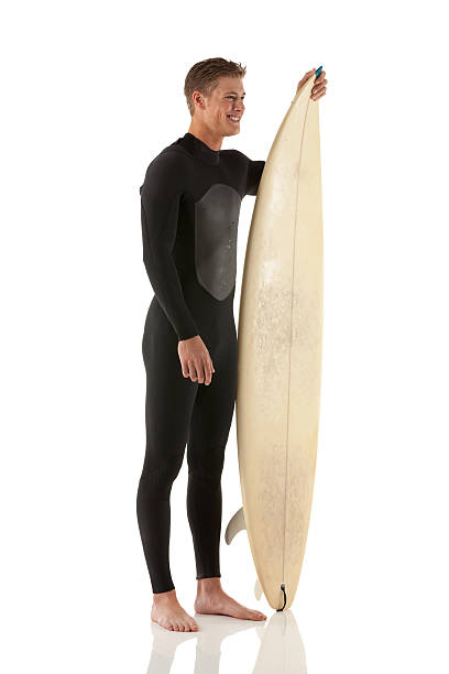 istock Happy male surfer standing with a surfboard 175255841