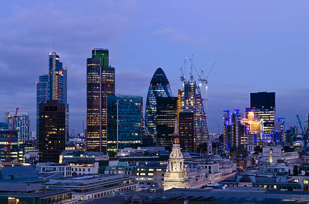 City of London skyscrapers at Dusk "Elevated view of The City of London at dusk. The City is London's traditional financial and global business district. The distinctive 'Gherkin' skyscraper, Tower 42 and the Heron Tower feature on the constantly changing skyline. To the left of the Gherkin a new skyscraper 122 Leadenhall Street, known as the Cheesegrater is taking shape." london gherkin at night stock pictures, royalty-free photos & images