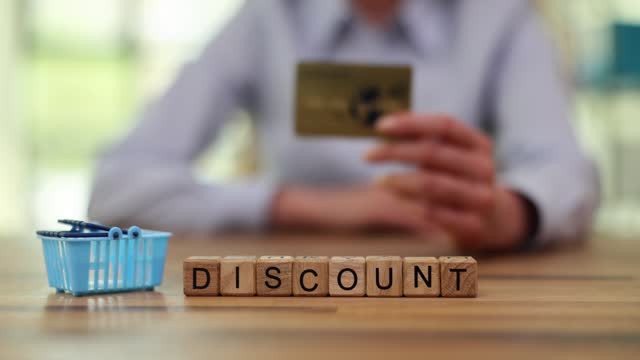 Word Discount from wooden blocks against shopping basket