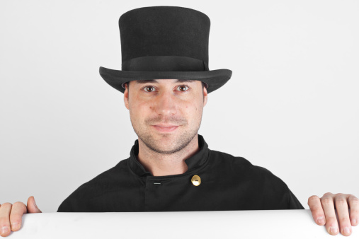 Patriotic businessman smiles for the camera with an oversize top hat and matching bow tie