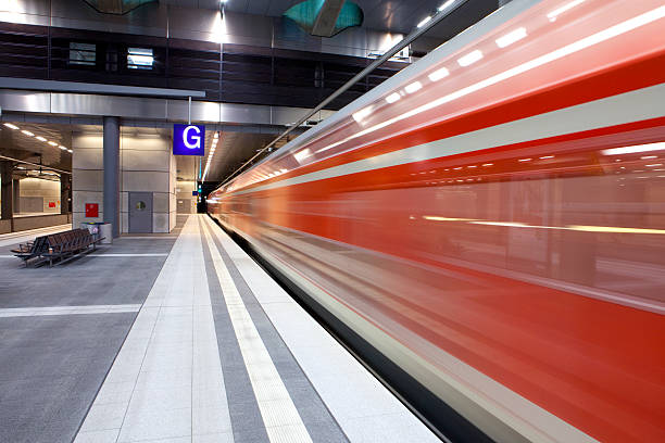 istock Blurred high speed commuter train speeding at railway station platform 175256498