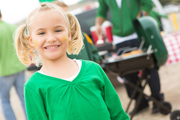 Cute girl in pigtails tailgating at stadium with her family Cute girl in pigtails tailgating at stadium with her family people family tailgate party outdoors stock pictures, royalty-free photos & images