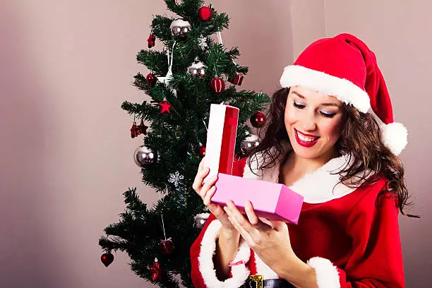 Mrs.Claus opening gift box and smiling