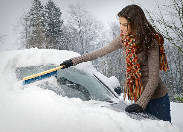 istock Woman freeing her car from Snow 175257414