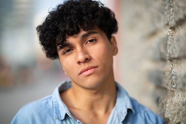 istock Close up cool young man with curly hair looking at camera 1752574498